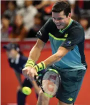  ?? — AFP ?? Canada’s Milos Raonic returns to Yosuke Watanuki of Japan in their second round match. Ronic won 6- 3, 7- 6 ( 7/ 2)