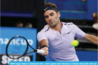  ?? — AFP ?? PERTH: Roger Federer of Switzerlan­d hits a return against Karen Khachanov of Russia during their sixth session men’s singles match on day four of the Hopman Cup tennis tournament in Perth yesterday.