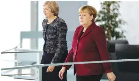  ??  ?? BERLIN: German Chancellor Angela Merkel (R) and Britain’s Prime Minister Theresa May arrive for a statement prior to a meeting at the Chanceller­y on Friday. —AFP