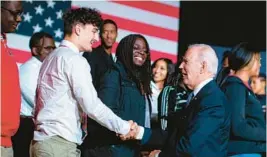  ?? AL DRAGO/THE NEW YORK TIMES ?? President Joe Biden meets with students after speaking about his student loan forgivenes­s plan Friday at Delaware State University in Dover, Delaware.