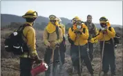  ??  ?? Members of the Amah Matsun Land Trust, get instructio­ns during the morning briefing from California State Parks Natural Resource Management before conducting a prescribed burn in Año Nuevo State Park on Nov. 19.