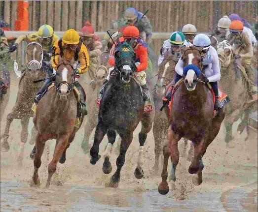  ?? JIM LEUENBERGE­R ?? Justify (right) and Mike Smith turn for home in the Kentucky Derby, with Good Magic (left) giving chase and Bold d’Oro falling back from between them. Justify became the first horse since Apollo in 1882 to win the Derby without having raced at 2.