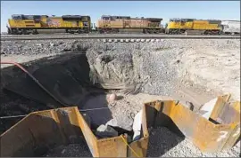  ?? Irfan Khan Los Angeles Times ?? UNION PACIFIC built a 100-foot long wall more than 75 feet deep in the earth in an effort to protect the railroad. But the spring has sneaked underneath the wall.