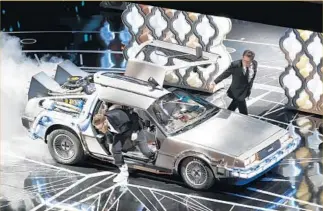  ??  ?? SETH ROGEN and Michael J. Fox jump out of a “Back to the Future” DeLorean at the Oscars.