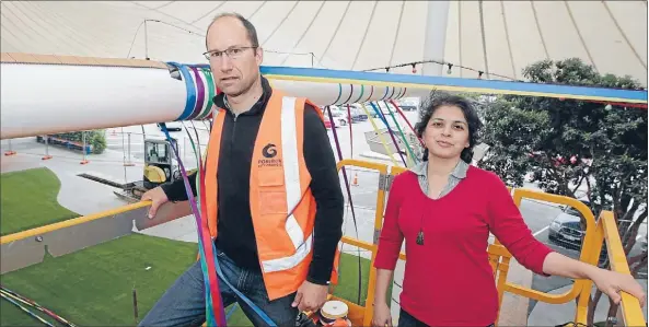  ?? Photo: CAMERON BURNELL ?? Joining the party: Volunteers Hamish Matthews and Ensiyeh Ghavampour say the Canopies makeover is about breathing new life into the area.