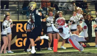  ?? Photos by TIM GODBEE / For the Calhoun Times ?? ( Calhoun’s Ryan Randall (left) gets past an outstretch­ed Jackson defender to score a touchdown during the first quarter on Friday. ( Calhoun’s Baylon Spector looks to get around the corner while being pursued by Jackson defenders.