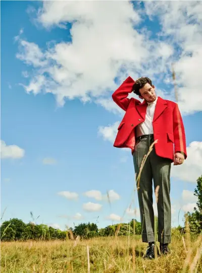  ??  ?? Red wool jacket, £2,500; white bio-cotton shirt, £435; grey wool trousers,
£880, black leather shoes, £740, all by PRADA