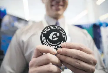  ?? CHRIS ROUSSAKIS/ NATIONAL POST FILES ?? A number of MPs are pushing the Conservati­ve Party to roll back a planned increase in membership dues. Above, a party hockey puck at a recent Manning Centre event.