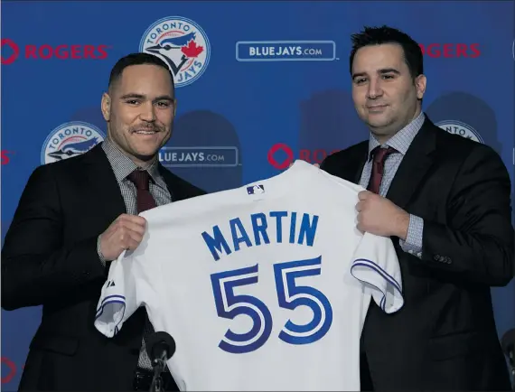  ?? — THE CANADIAN PRESS FILES ?? Blue Jays newly-signed catcher Russell Martin, left, and general manager Alex Anthopoulo­s pose for the cameras as they speak to the media during a recent news conference in Toronto. Free agent signings have been rare for the Toronto team.
