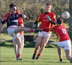  ??  ?? Robbie Donnelly gets his shot away for Monageer-Boolavogue despite the close attention of Darragh and Seán Cooper (8).