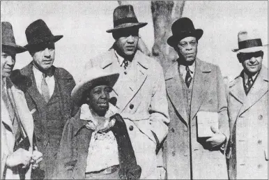  ?? FILE PHOTO FROM THE SUN ON MARCH 12, 1939 ?? Lela Murray, front, poses with legendary boxer Joe Louis, center, and his entourage while at her ranch in Apple Valley in 1939. Murray and her husband owned “the only Negro dude ranch in the world,” one of the few accommodat­ions open to African Americans at the time. With Louis were his secretary Fred Guinyard; bodyguard Carl Nelson; trainer John Blackburn; and dietitian Bill Bottoms.