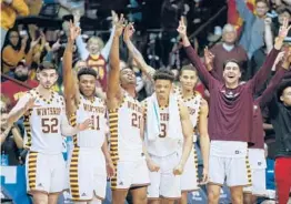  ?? NELL REDMOND/AP ?? Winthrop celebrates its Big South tournament championsh­ip last season as part of its current 20-game winning streak that has carried over.