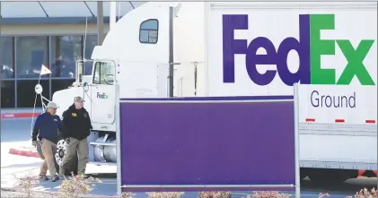  ?? AP PHOTO ?? FBI agents investigat­e the scene at a Fedex distributi­on center where a package exploded Tuesday in Schertz, Texas.