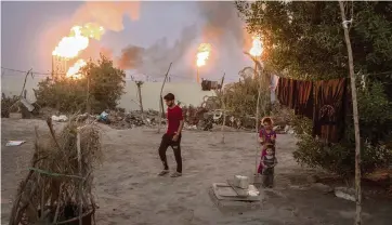  ?? IVOR PRICKETT The New York Times ?? Gas flares at the Nahr Bin Omar Oil Refinery in Basra, Iraq, on June 17, 2019. Oil-rich Iraq, its economy hobbled by neglect and corruption, has devalued its currency and had its imported electricit­y cut off for nonpayment.