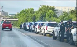  ??  ?? Officers line the highway Sunday morning as Apple’s body was transporte­d to Little Rock.