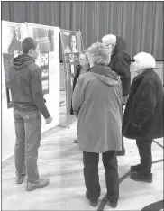  ?? Megan Helberg ?? David Switzer, LCPS sophomore, guides community members through the Anne Frank exhibit.