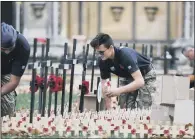  ?? PICTURES: PA ?? PREPARATIO­N: Work starts on laying crosses in the Field of Remembranc­e at Westminste­r Abbey, ahead of Armistice Day. Captain Sir Tom Moore will feature in the Festival of Remembranc­e.