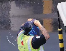  ?? MATT YORK/ASSOCIATED PRESS ?? An American Airlines ground crew member at Sky Harbor Internatio­nal Airport puts on a wet hat to combat the heat on Tuesday in Phoenix, where the temperatur­e hit 118 on Monday.