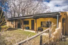  ?? NATHAN BURTON/Taos News ?? While looking through Gonzales-Kimbrough’s house, Paxton and his team searched for relics of local family history.