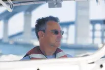  ??  ?? North Carolina Dept. of Transporta­tion resident engineer Pablo Hernandez drives a boat through the Oregon Inlet, where the new 2.8-mile Marc Basnight Bridge is located.