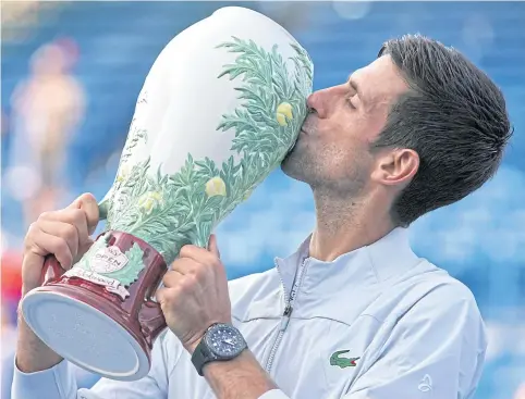  ?? USA TODAY SPORTS ?? Novak Djokovic celebrates with the trophy after defeating Roger Federer in the Cincinnati final.