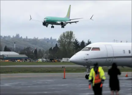  ?? TED S. WARREN — THE ASSOCIATED PRESS FILE ?? In this file photo a Boeing 737 MAX 8 airplane being built for India-based Jet Airways, top, lands following a test flight, Wednesday at