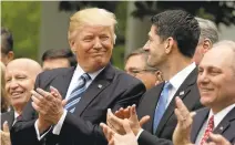  ?? EVAN VUCCI/ASSOCIATED PRESS ?? President Donald Trump and House Speaker Paul Ryan applaud after the House passed their health care bill Thursday.