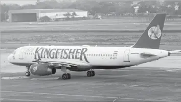  ??  ?? A KINGFISHER Airlines aircraft taxis on the tarmac at Mumbai’s domestic airport. — Reuters