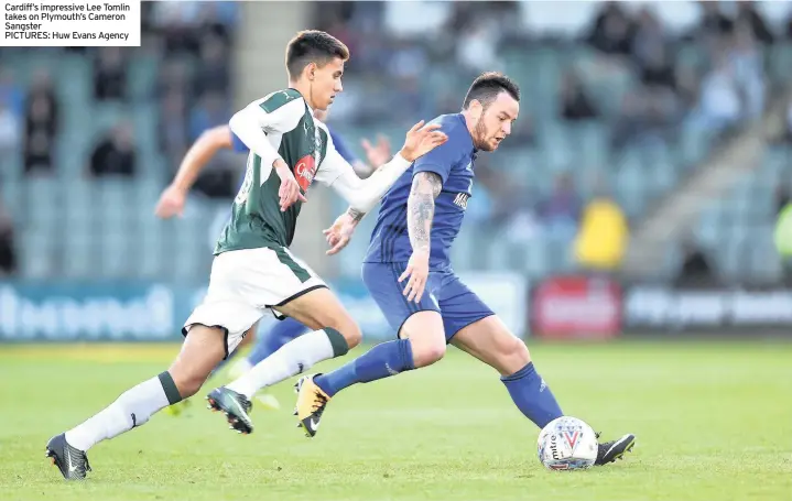  ?? PICTURES: Huw Evans Agency ?? Cardiff’s impressive Lee Tomlin takes on Plymouth’s Cameron Sangster