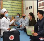  ?? ?? In this photo provided by the North Korean government, a doctor visits a family Tuesday during an activity to raise public awareness of covid-19 prevention measures in Pyongyang. Independen­t journalist­s were not given access to cover the event depicted in this image. The content of this image is as provided and cannot be independen­tly verified.
(AP/Korean Central News Agency/Korea News Service)