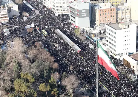  ?? — AFP photo ?? A handout picture provided by the office of Iran’s Supreme Leader Ayatollah Ali Khamenei shows mourners gather to pay homage to Soleimani, after he was killed in a US strike in Baghdad, in the capital Tehran.