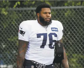  ?? Steven Senne / Associated Press ?? Patriots offensive tackle Isaiah Wynn steps on the field at the start of practice on Aug. 1 in Foxborough, Mass.