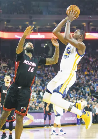  ?? Scott Strazzante / The Chronicle ?? Forward Kevin Durant, shooting against Miami’s James Johnson in the first quarter, led the Warriors with 28 points. He’s averaging 26 points this season in about 35 minutes per game.