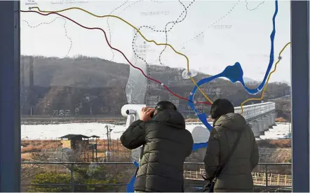 ?? AFP Fragile divide: ?? Visitors looking through binoculars during a visit to the Imjingak peace park near the Demilitari­sed Zone dividing the two Koreas at the border city of Paju in South Korea. —
