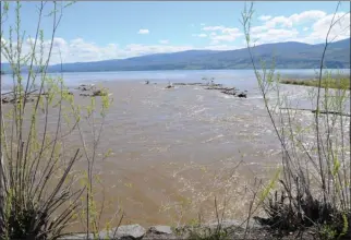  ?? Daily Courier file photo ?? Powers Creek spills into Okanagan Lake last May. The creek spilled its banks a year ago, and floodrecov­ery work along the creek will cost more than twice as much as was projected, West Kelowna city council will hear today.