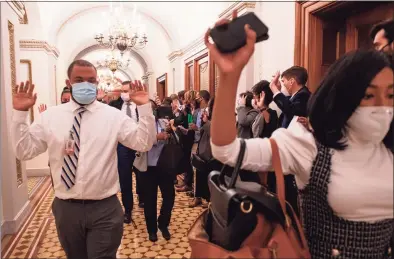  ?? Amanda Voisard / For The Washington Post ?? Congressio­nal staff members are ushered out of the Capitol after rioters breached the building, interrupti­ng a joint congressio­nal session to count the electoral college vote in Washington.