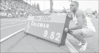  ??  ?? Christian Coleman of Tennessee poses with scoreboard after winning 100m heat in a collegiate record 9.82 during the NCAA Track and Field Championsh­ips at Hayward Field (Kirby Lee-USA TODAY Sports)