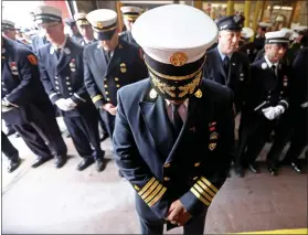  ?? STUART CAHILL — BOSTON HERALD ?? BFD Rodney Marshall, Chief of Operations Support, bows his head at a memorial held Tuesday at the station for Engine 33and Ladder 15for firefighte­rs that lost their lives 10years ago at the Beacon Street fire.