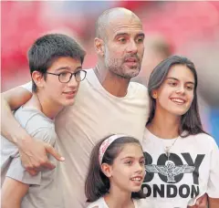  ?? REUTERS ?? Pep Guardiola poses with his children after winning the Community Shield.