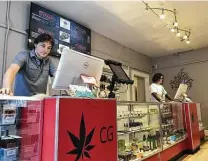  ?? Associated Press file photo ?? Korbin Osborn, left, works as a cannabis adviser at a medical marijuana dispensary in Santa Fe, N.M., in 2019.