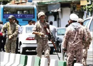  ?? HOSSEIN MERSADI/AFP ?? Members of the Iranian Revolution­ary Guard secure the area outside the Iranian parliament during an attack on the complex in the capital Tehran on Wednesday.