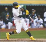  ?? GODOFREDO A. VÁSQUEZ VIA AP ?? OAKLAND ATHLETICS’ ABRAHAM TORO hits an RBI double against the Washington Nationals during the seventh inning of a game on Saturday in Oakland, Calif.