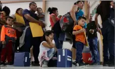  ?? AP PHOTO/ ERIC GAY ?? Immigrant families seeking asylum wait in line at the central bus station after they were processed and released by U.S. Customs and Border Protection on Friday in McAllen, Texas.