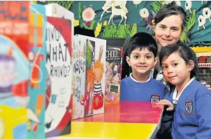  ??  ?? ●● Caryl Hart pictured with King’s Infant bookworms Layth Loota and Kanya Langhorn-Neillans