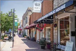  ?? ALYSSA POINTER/AJC 2019 ?? City leaders plan a block party in Stone Mountain Village, the quaint downtown district. The June 19 event will feature dancers, drummers, church choirs, fireworks, speeches from dignitarie­s and other festivitie­s.