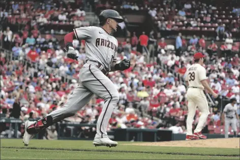  ?? JEFF ROBERSON/AP ?? ARIZONA DIAMONDBAC­KS’ NICK AHMED, left, rounds the bases after hitting a solo home run off St. Louis Cardinals starting pitcher Miles Mikolas (39) during the eighth inning of a game Saturday in St. Louis.