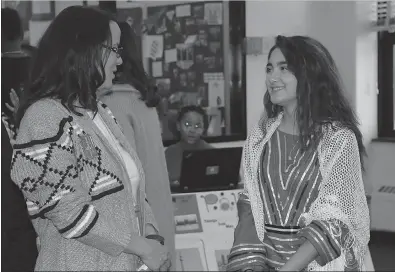  ?? SUBMITTED PHOTOS ?? Maurice J. McDonough High School teacher Karena Bennett, left, speaks with Ellie Karimi, a former student at the school who helped start the Internatio­nal Club. Karmini, a native of Iran, helped organize the festival the club holds to introduce various...