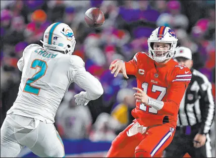  ?? Adrian Kraus The Associated Press ?? Bills quarterbac­k Josh Allen throws a pass Dec. 17 while under pressure by Dolphins linebacker Bradley Chubb. Buffalo won 32-29 in closing the season 7-0. Miami stumbled down the stretch.