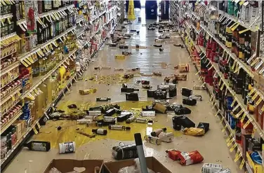  ?? Rex Emerson via AFP ?? Broken bottles and other items litter the floor of a store in Lake Isabella, Calif., after a 6.4 magnitude earthquake hit Southern California in San Bernardino County on Thursday morning.