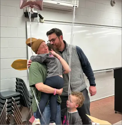  ?? SENTINEL & > ENTERPRISE / NICK MALLARD ?? Memorial Middle School teacher Siobhan Donovan hugs her daughter Shea, as her husband,mike and son Bo look on during a celebratio­n for her on Friday afternoon.